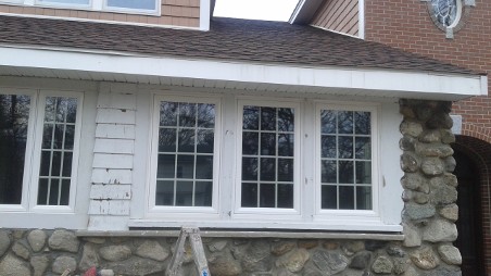 Single-story house exterior with large white-framed windows.
